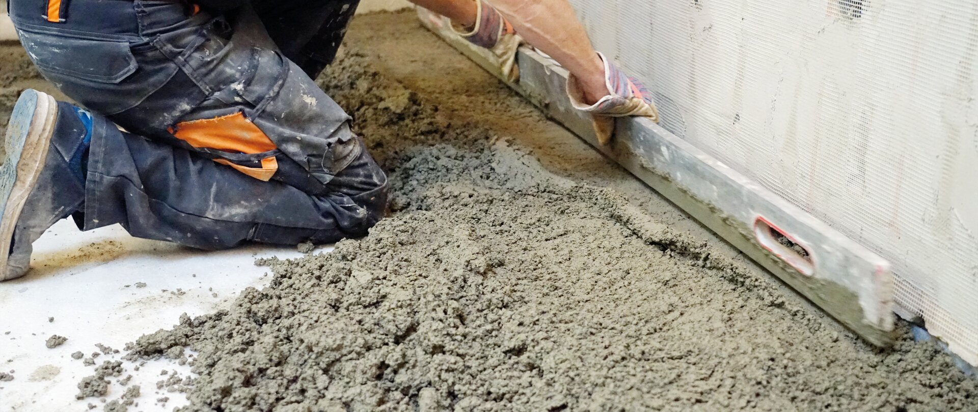 Worker pouring cement mix concrete in bucket Stock Photo