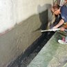 Plastering concrete surfaces with spray plaster